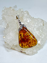 Charming Silver floral Wrapped Amber Pendant